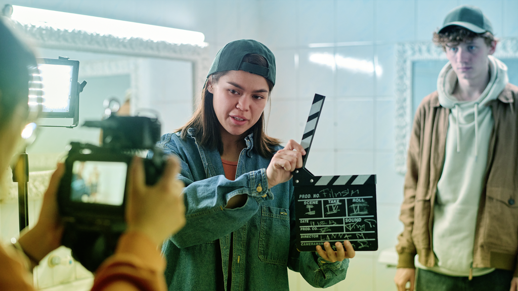 student filmmakers filming in a public restroom